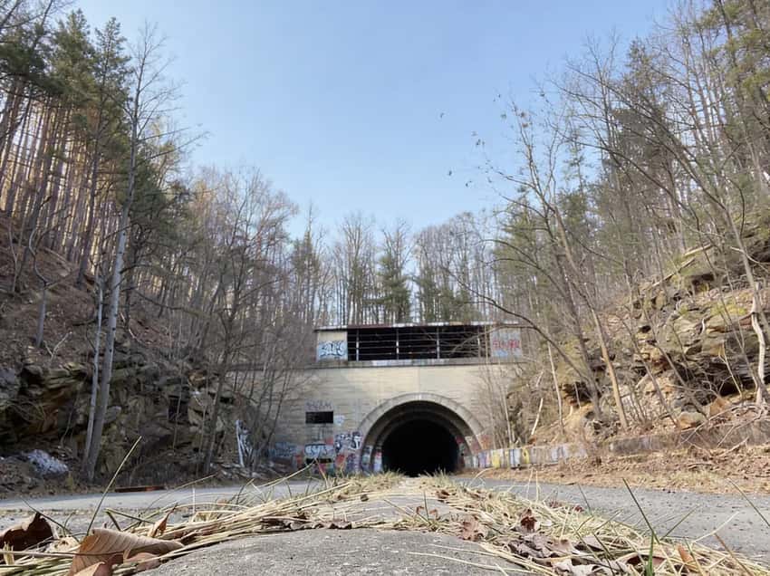 A cyclist's POV riding through the dark tunnels of the abandoned turnpike